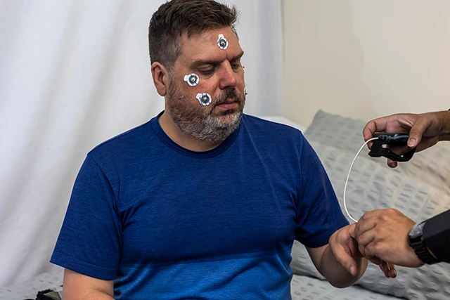 Man being connecteed for sleep study