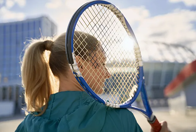 Image of female with tennis racket